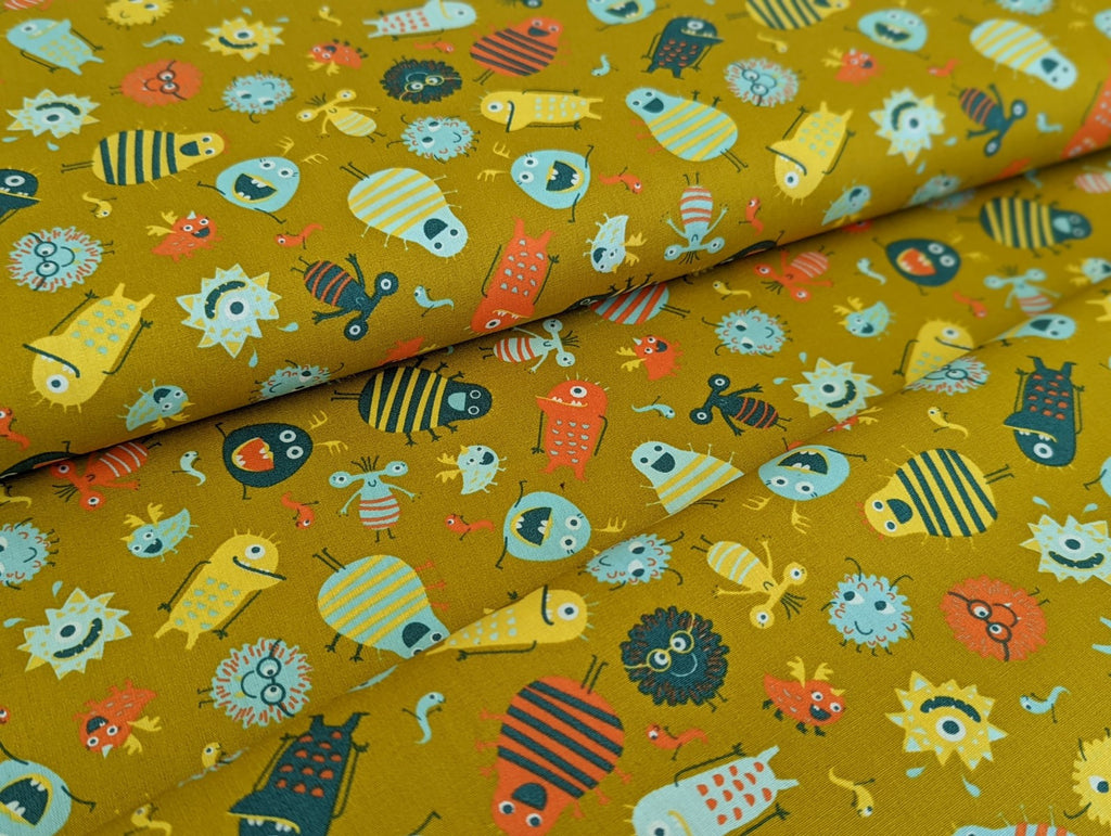 Cotton fabric Poplin Small Aliens Monsters on Mustard Yellow