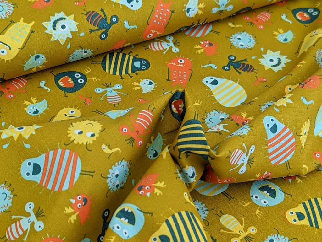 Cotton fabric Poplin Small Aliens Monsters on Mustard Yellow