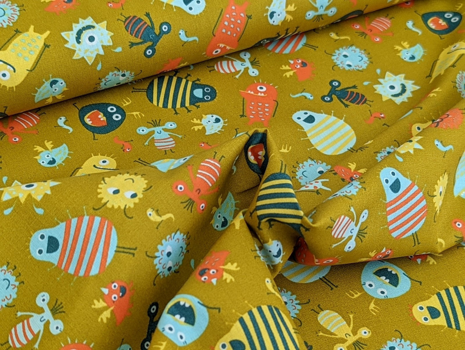 Cotton fabric Poplin Small Aliens Monsters on Mustard Yellow