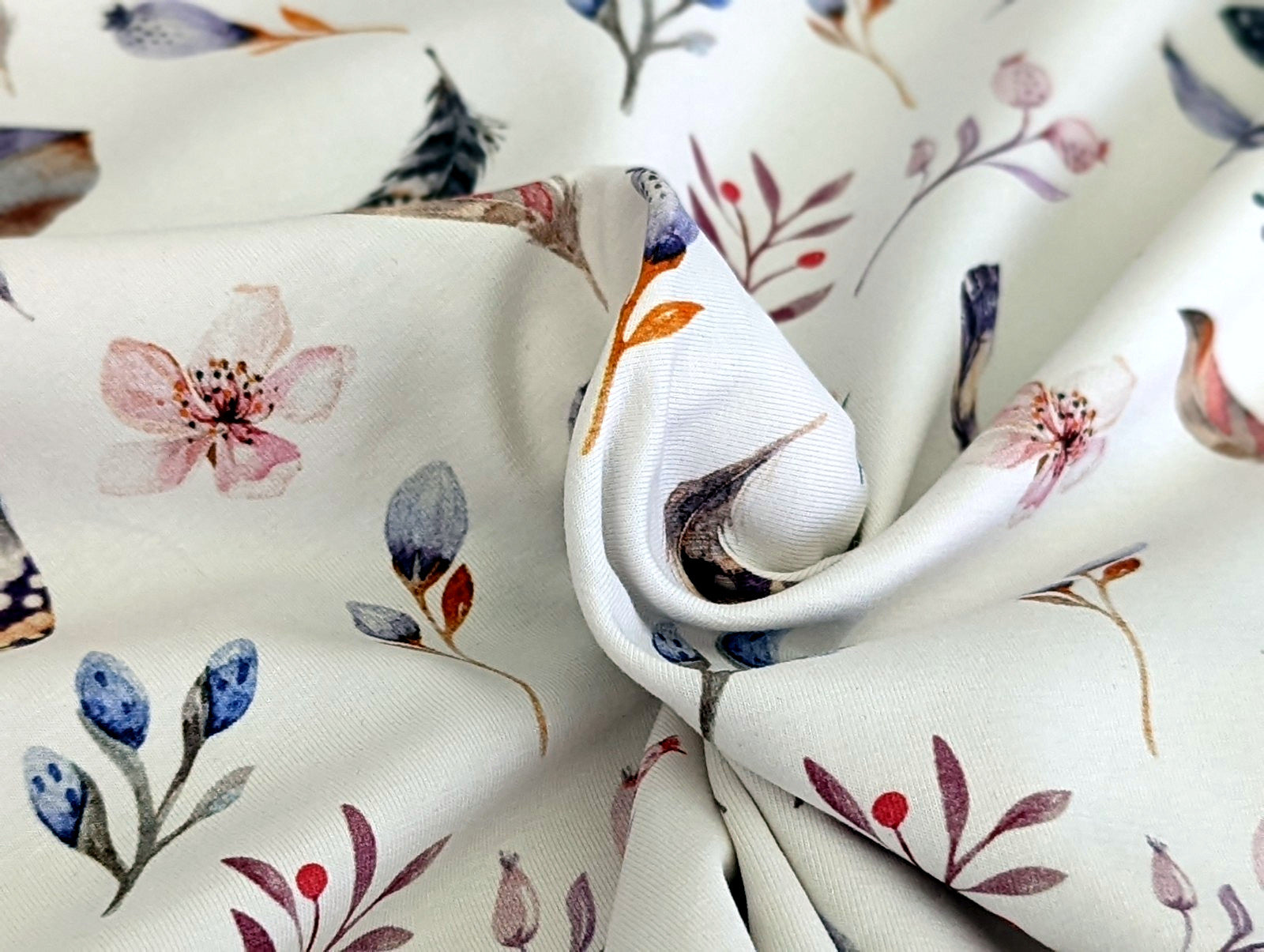 Cotton jersey Small feathers, branches, and cherry blossoms on off-white